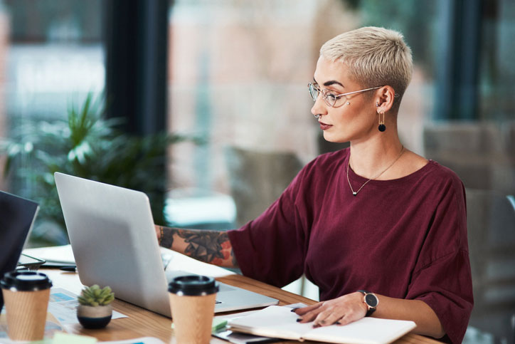 queer student working on computer