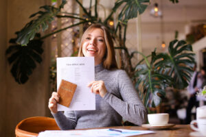 woman holding up passport application