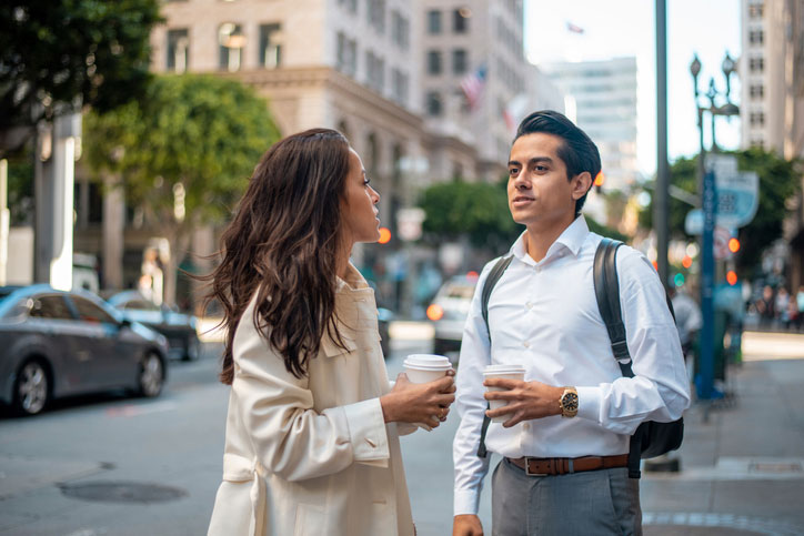 two latinos talking while having coffee