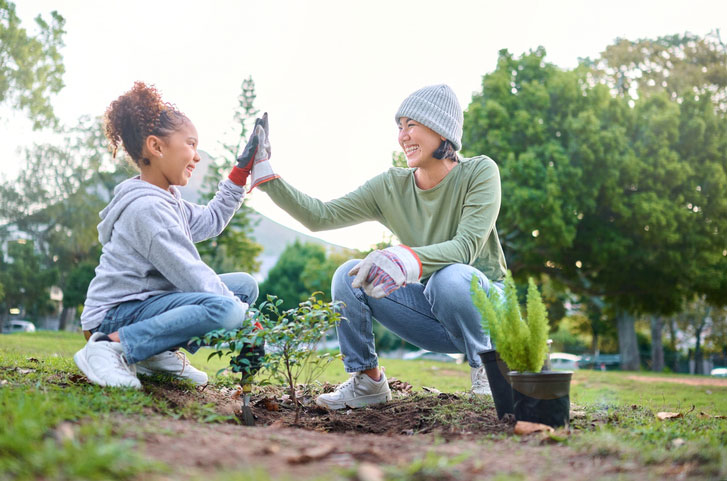 two young women planting trees