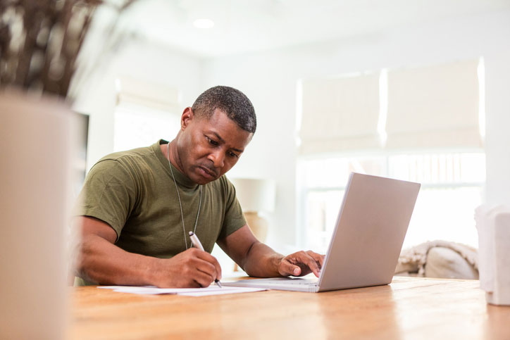 hard working vet on his computer