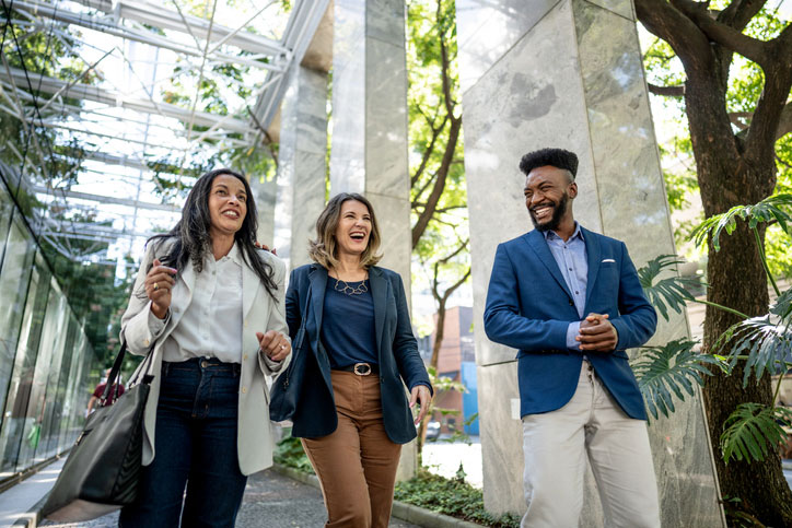 small group of business people walking and talking