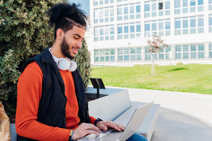 student using laptop outside