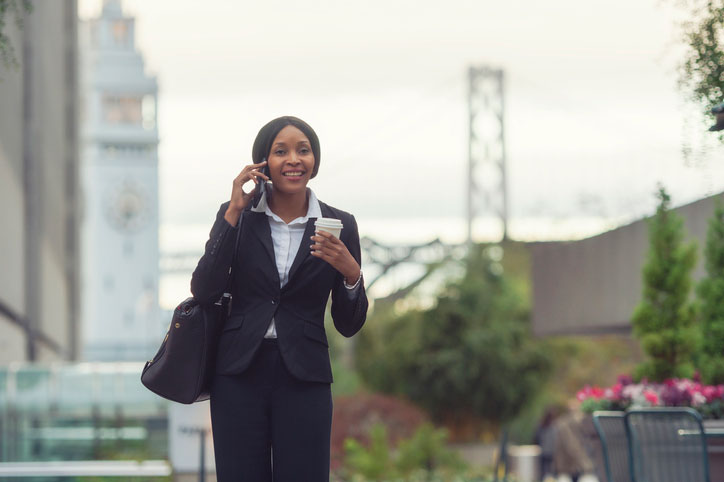 business woman walking on the phone, with the golden gate bridge in the background