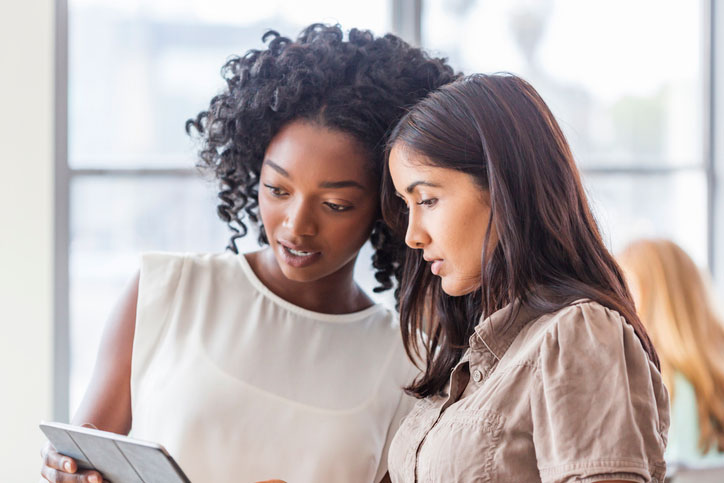 two women working together