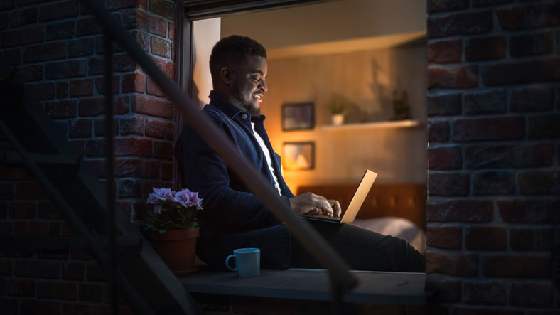 man working late on laptop at home