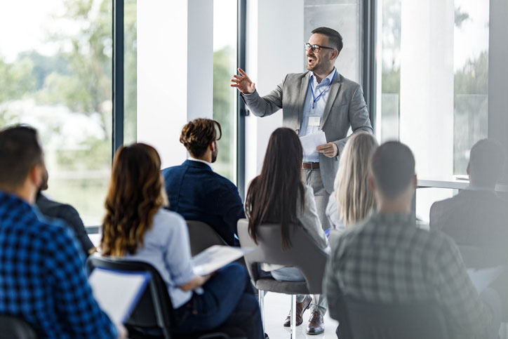 business leader giving seminar in small office