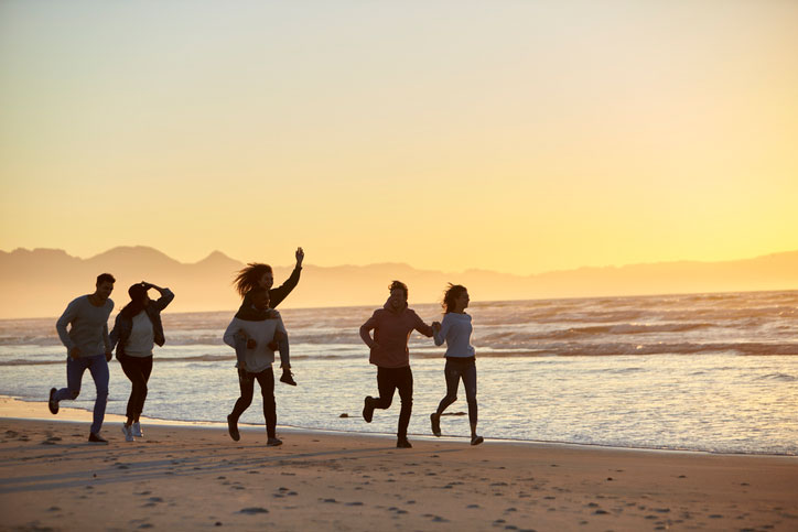 running with friends on the beach