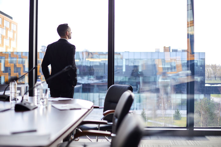 businessman looking out office window