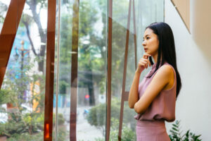 woman looking thoughtfully out window