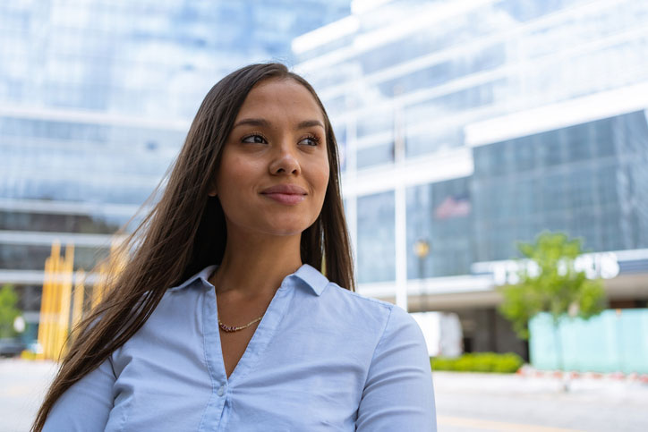 confident young woman outside of business complex