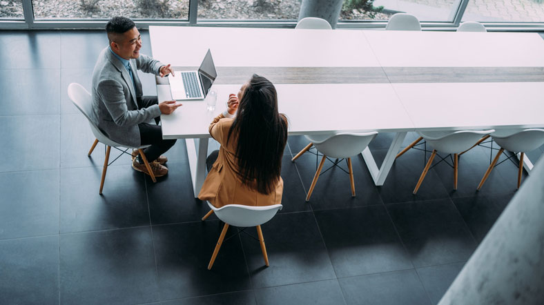 two colleagues in a large office